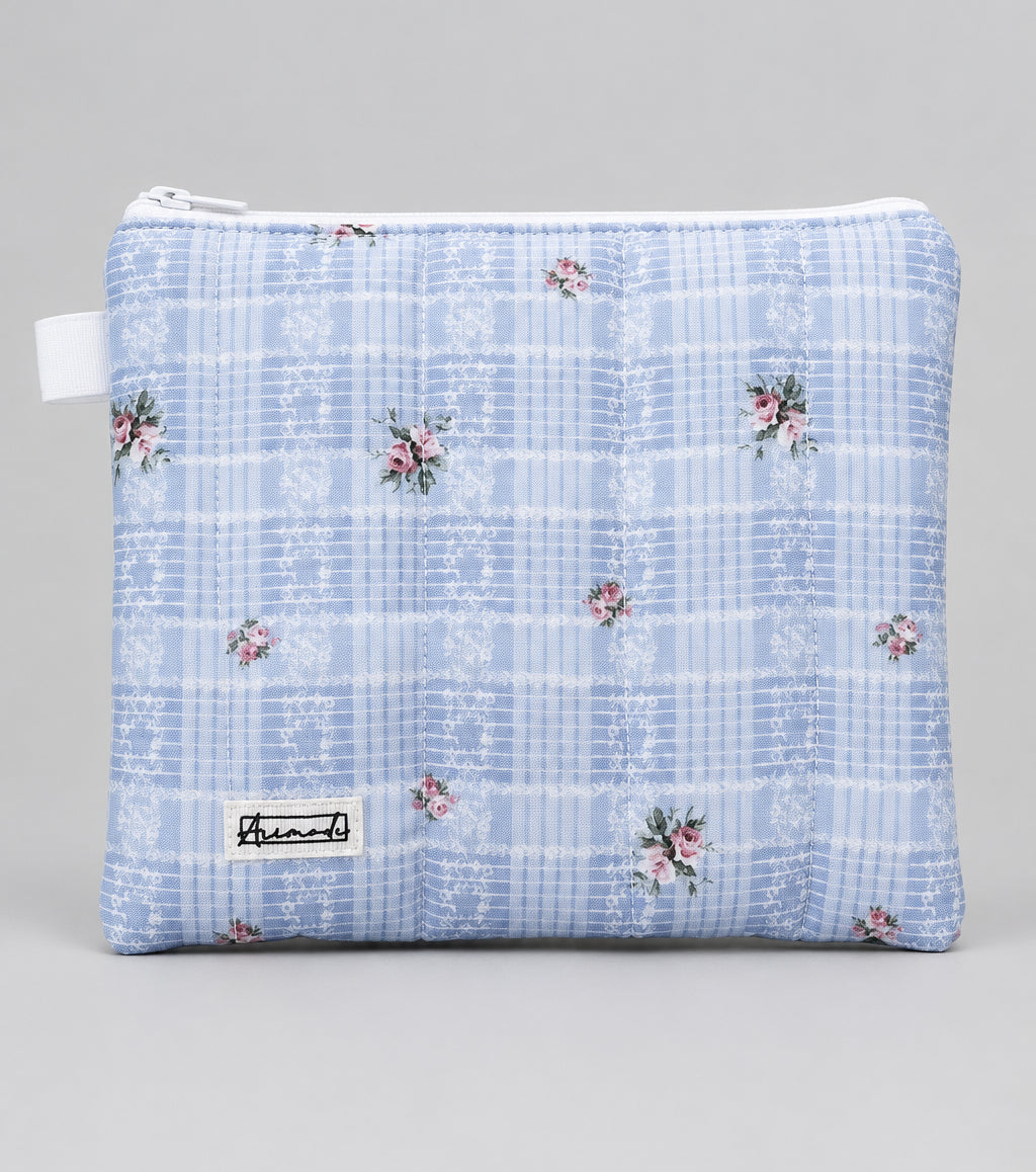 A light blue and white plaid zippered pouch with small pink floral accents.