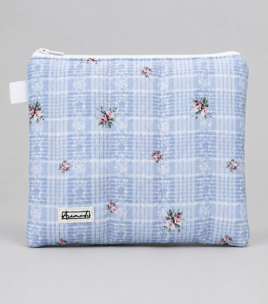 A light blue and white plaid zippered pouch with small pink floral accents.