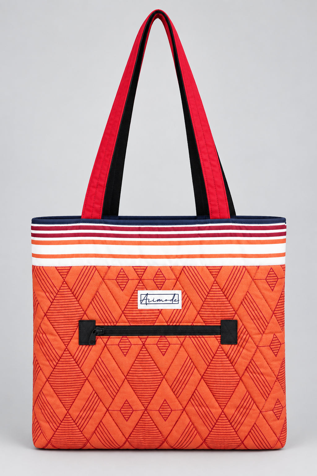 An orange quilted tote bag with a geometric diamond pattern, featuring a striped top border, a black front pocket with red shoulder straps with black inner lining.